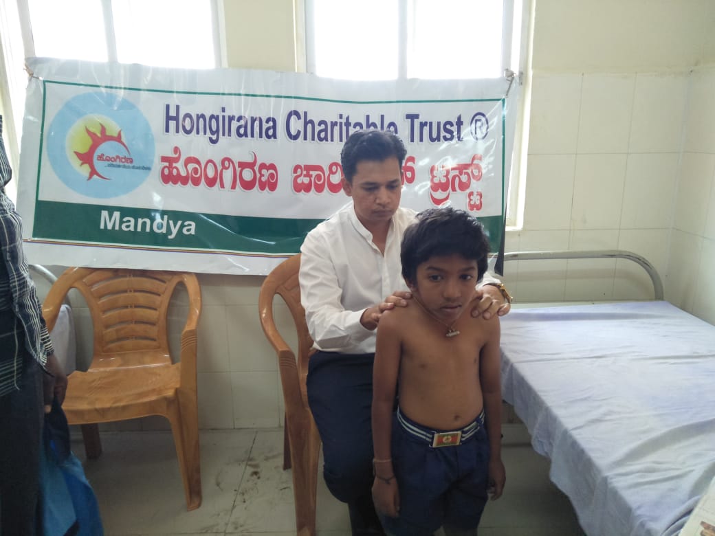 A young boy receives a clinical examination at a Hongirana health camp in Mandya.
