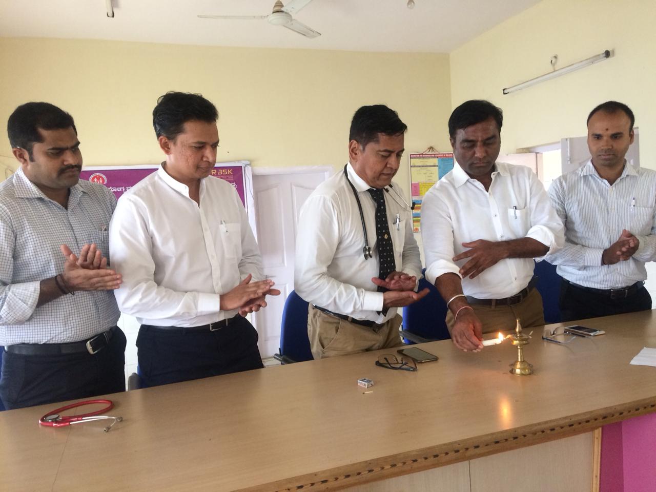 Lamp-lighting at the inauguration of a Hongirana–RBSK health camp, attended by paediatricians and district health officers.