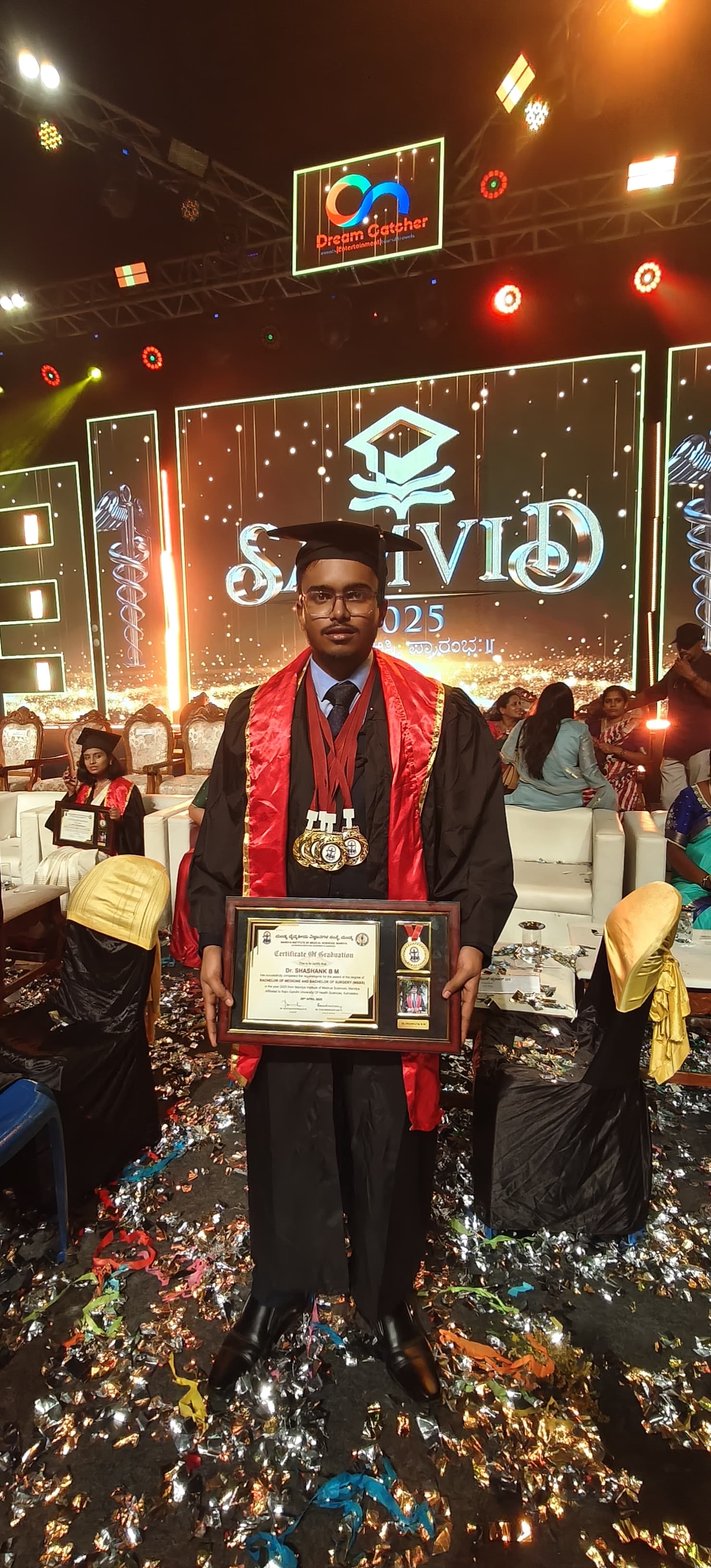 Dr. Shashank B M at his MBBS graduation, holding his certificate and medals