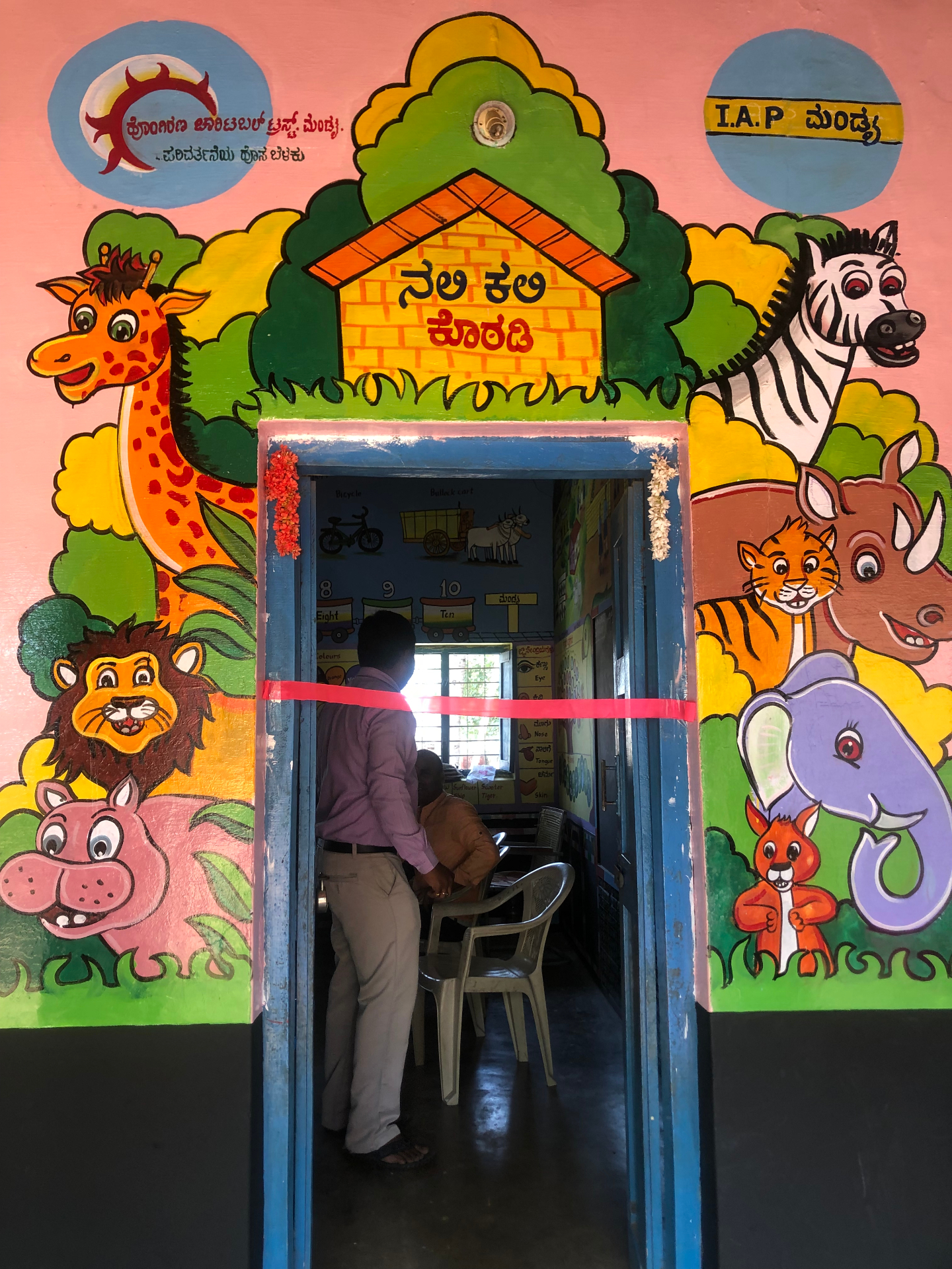 Refurbished Nali-Kali learning room entrance — painted with the Hongirana and IAP Mandya partnership marks.